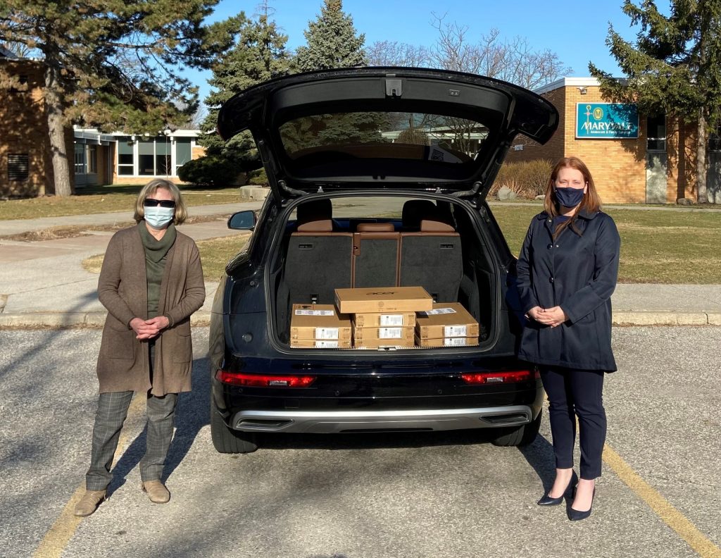 Plasman employee posing with Maryvale employee for donation of laptops to the local children's organization