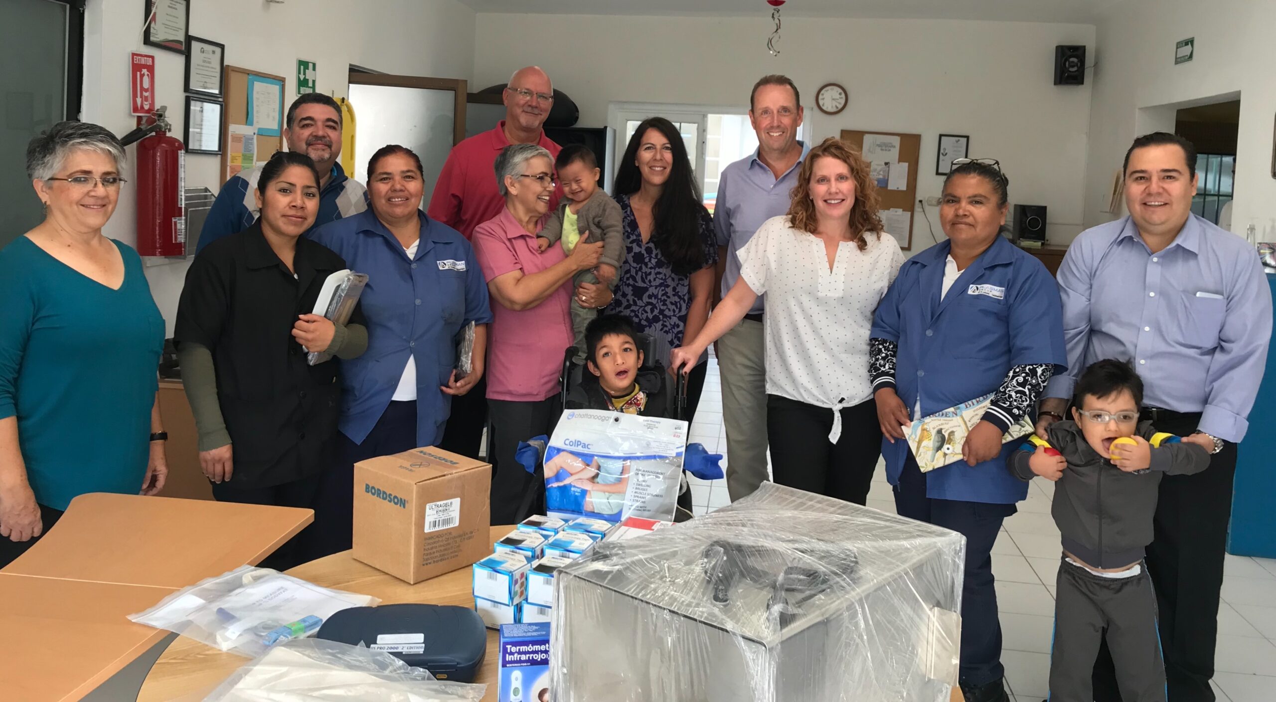 Plasman employee posing with Nens de Llum employees and children following donation to charity in Queretaro, Mexico