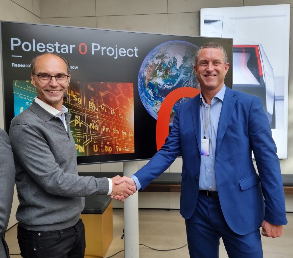Niklas Berntsson, President, EU, Plasman and representative from Polestar shaking hands in front of Polestar O Project sign