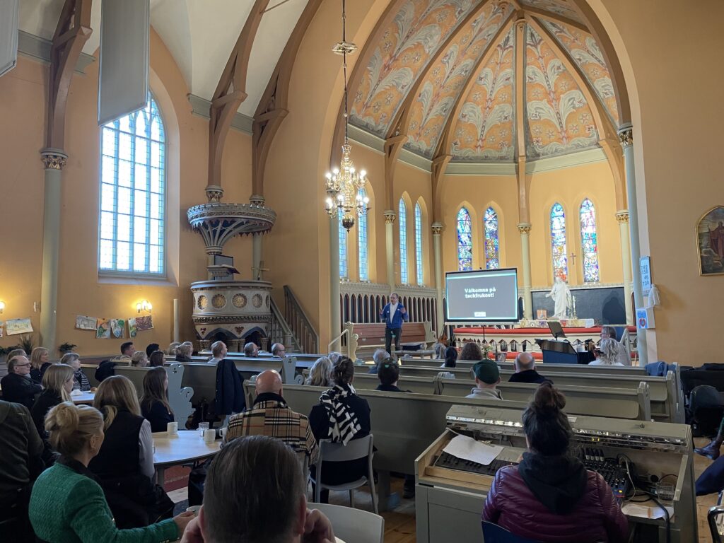 Plasman employees listen to speaker at St. Johannes Church Gothenburg, Sweden for Gothenburg City Mission