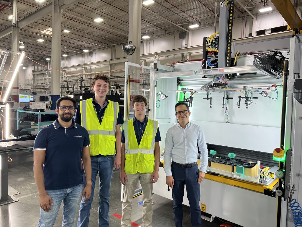 4 ppl, left to right Plasman employee, intern, intern and plasman employee on Plant floor