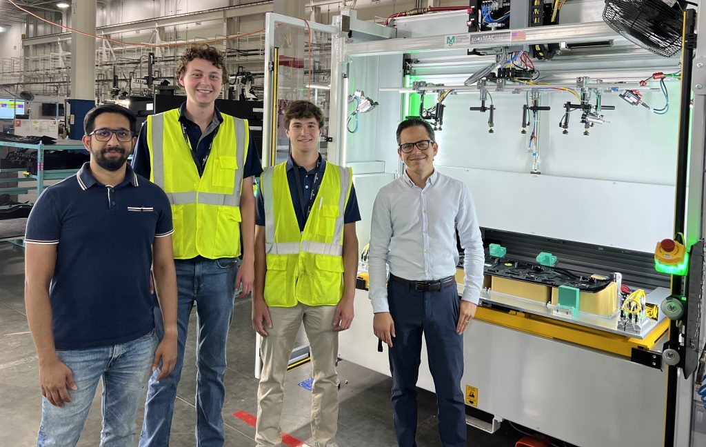 4 ppl, left to right Plasman employee, intern, intern and plasman employee on Plant floor