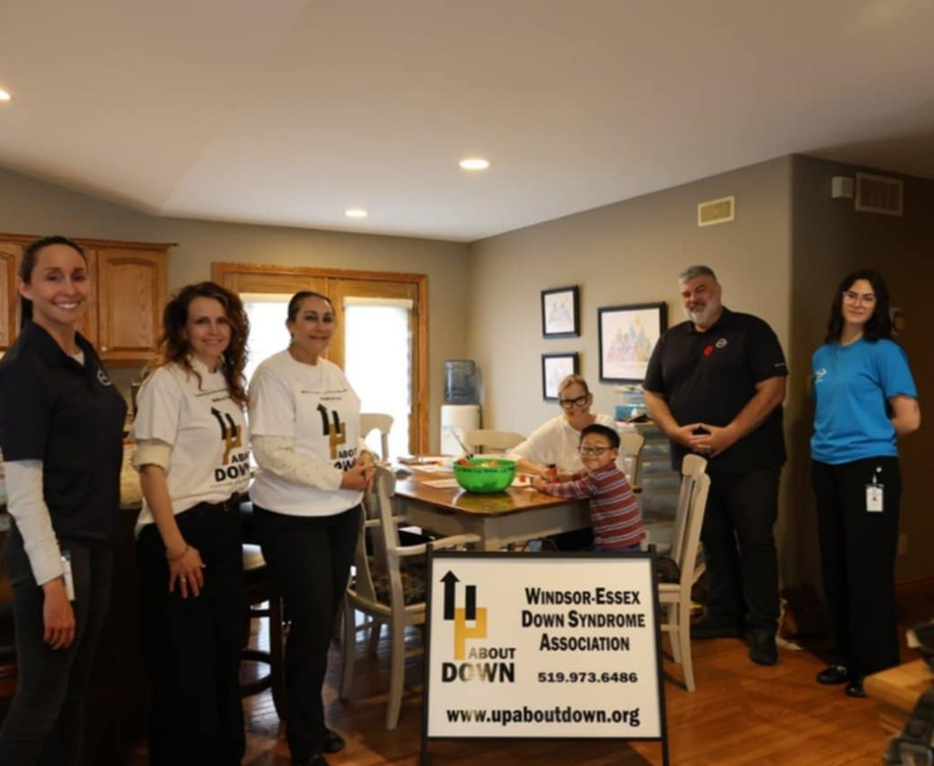 Group of people, the teacher, child and MVP ambassadors around a kitchen table