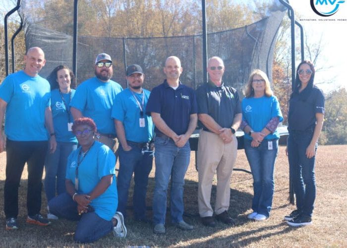 Plasman Fort Payne Manufacturing employees in front of trampoline donated to Southeastern Children's Home